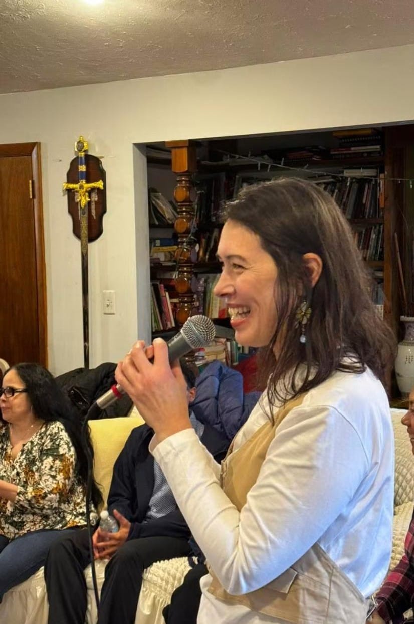 Jane laughing while speaking with a microphone