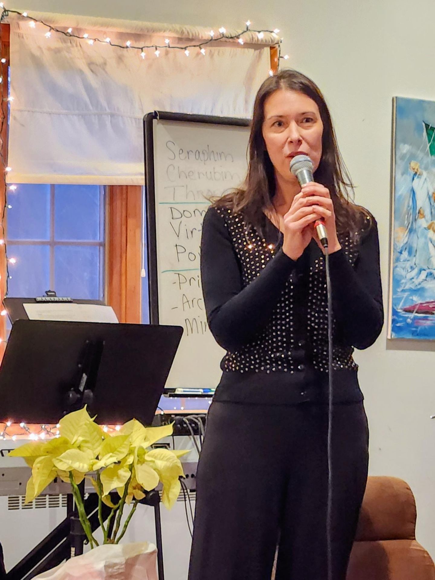 Jane speaking with a microphone in an intimate setting