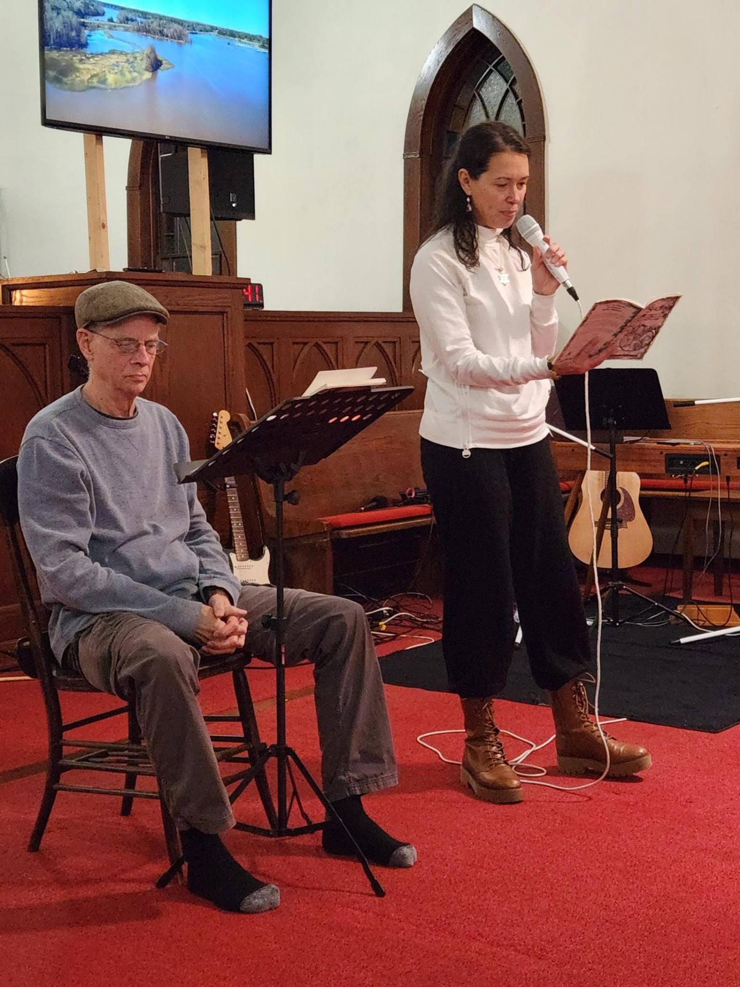 Jane reading from a book on stage